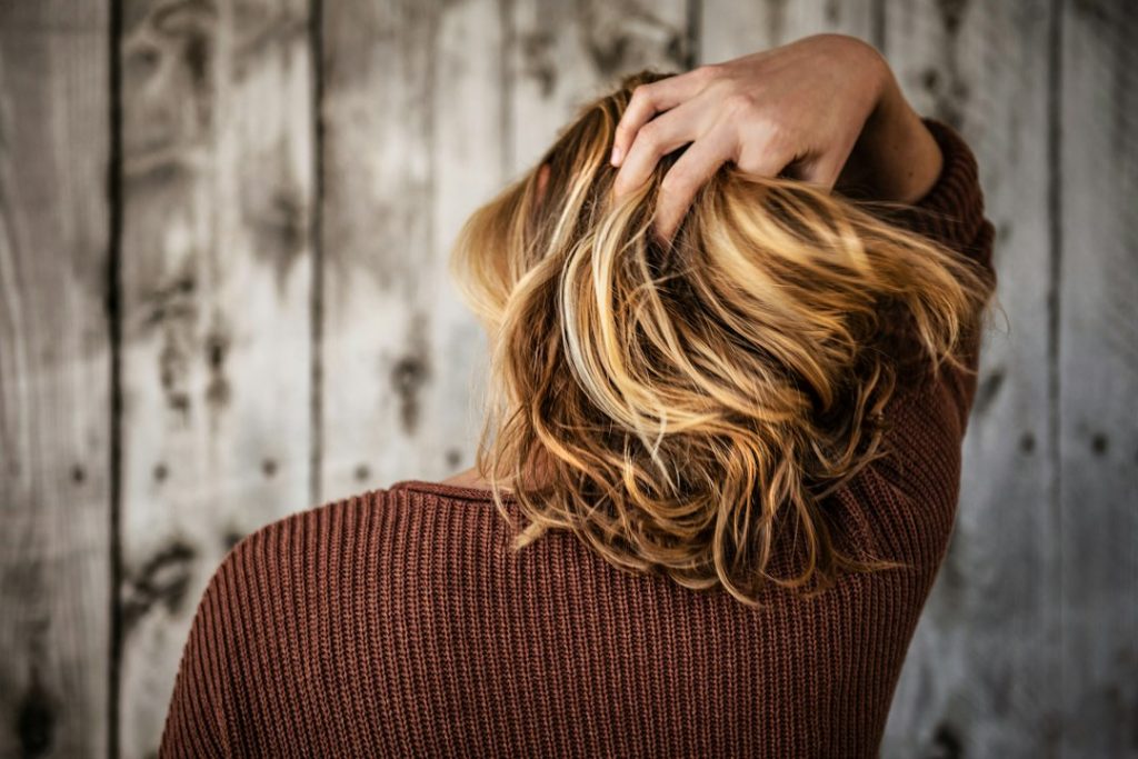 Close-up of hair being combed with fingers